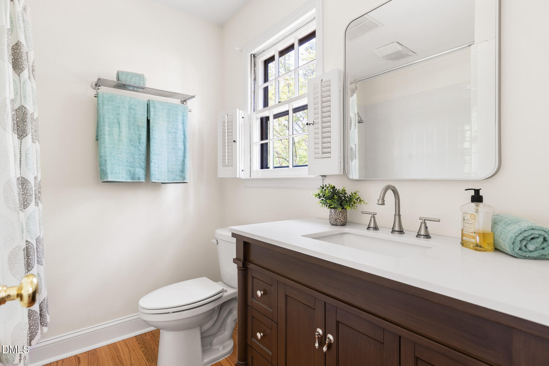 1706 Wallace Street Durham, NC 27707 - Photo 37 of 55 a bathroom with a sink a toilet and mirror