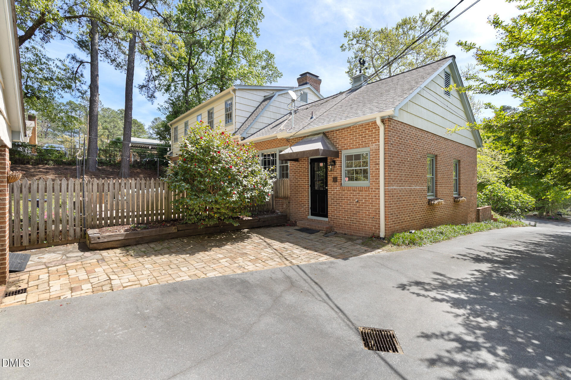 1706 Wallace Street Durham, NC 27707 - Photo 47 of 55 a view of a white house with a large tree and wooden fence