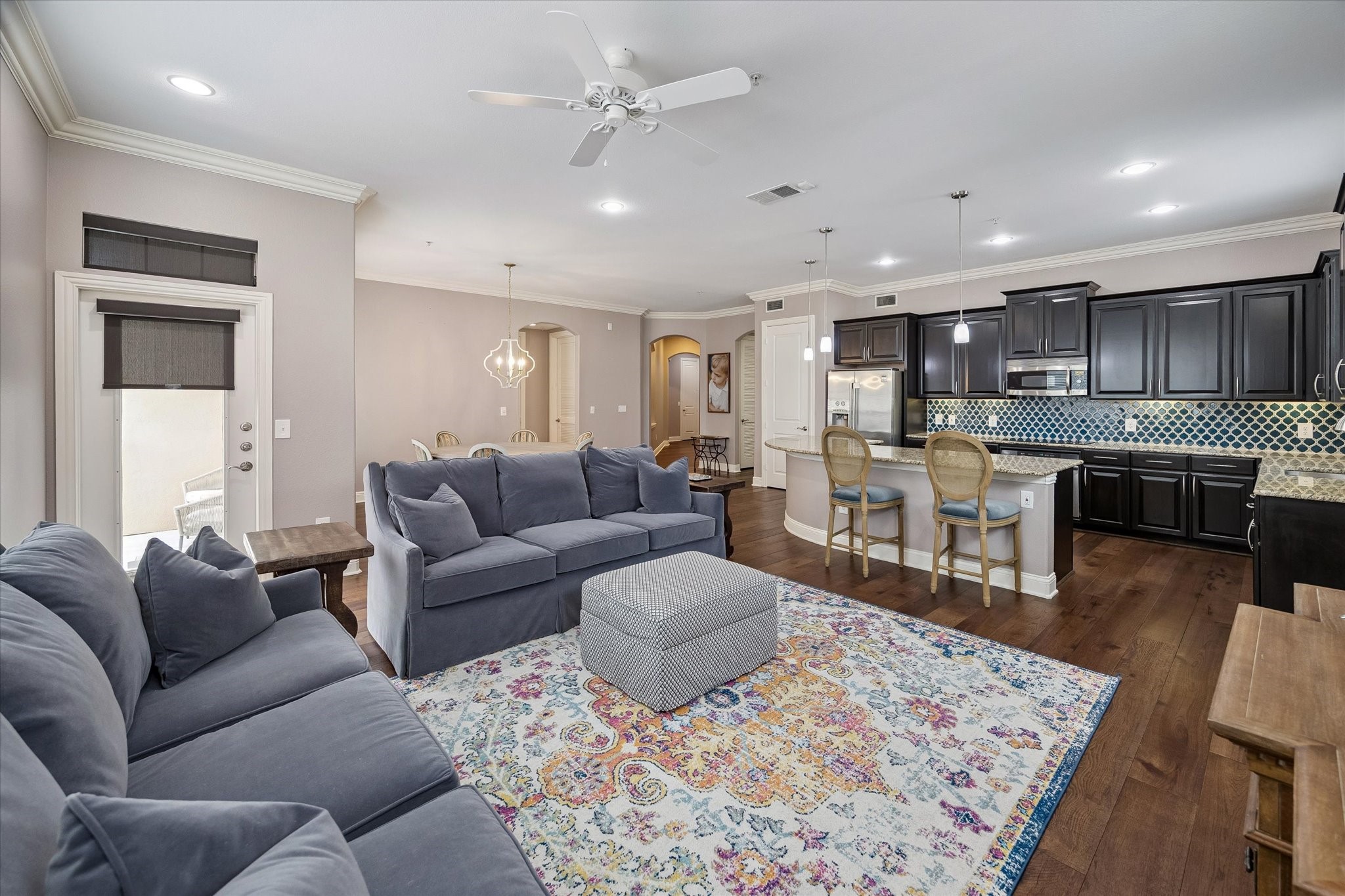 2120 Kipling Street, Unit 304 Houston, TX 77098 - Photo 11 of 24 Designed for comfortable everyday living, the living room features wide wood flooring, detailed crown molding, and an airy open-concept layout. Large windows brighten the space while the adjoining dining area and private balcony create the perfect setting for entertaining guests.