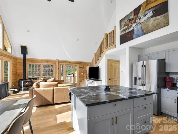 a living room with granite countertop kitchen island furniture and a large window