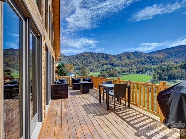 a view of a balcony with chairs and wooden floor