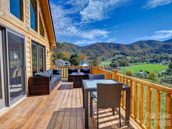 a view of a balcony with chairs and wooden floor