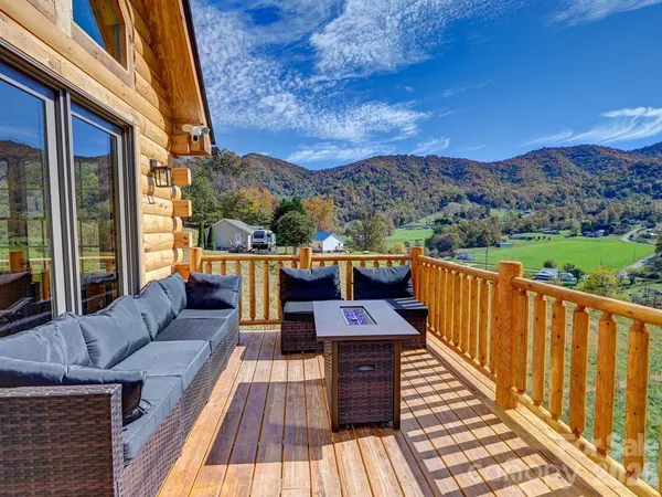 a view of balcony with furniture and wooden floor