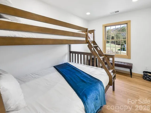 a bedroom with a bed window and a table