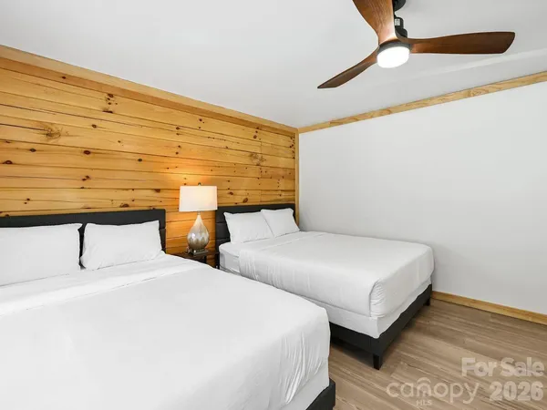 a bedroom with two beds and painted walls