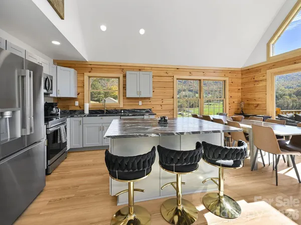a kitchen with lots of counter top space and stainless steel appliances