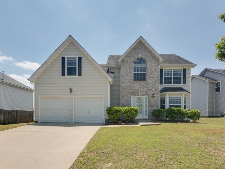 6064 Red Top Loop Union City, GA 30291 - Photo 1 of 10 a front view of a house with a yard and garage
