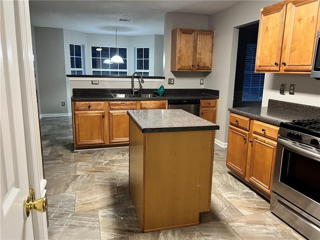 6064 Red Top Loop Union City, GA 30291 - Photo 2 of 10 a kitchen with stainless steel appliances granite countertop a stove a sink and a microwave