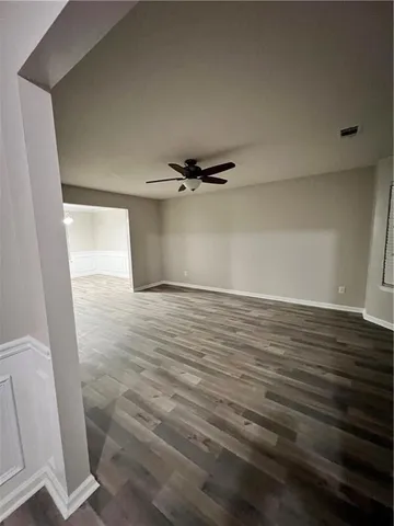 a view of a room with wooden floor