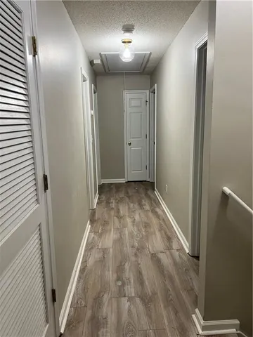 a view of hallway with wooden floor