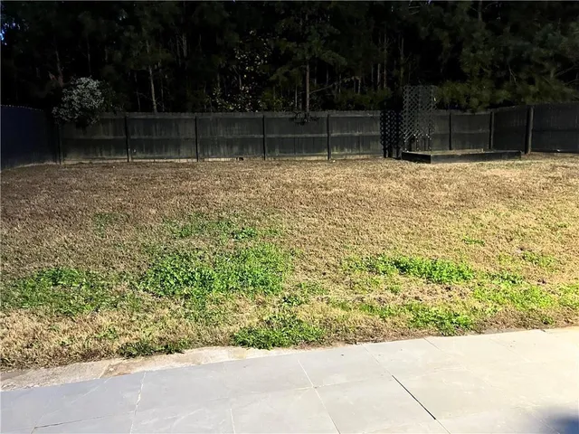 a backyard of a house with lots of green space