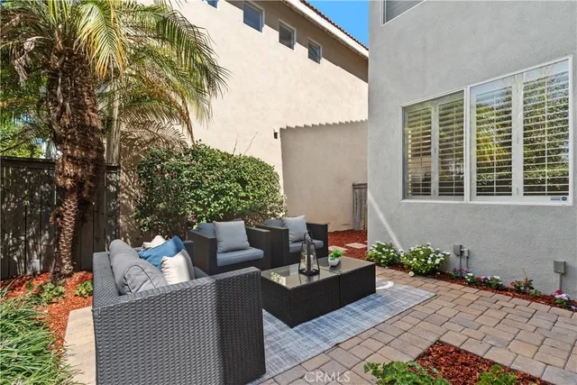 a view of a house with backyard and sitting area