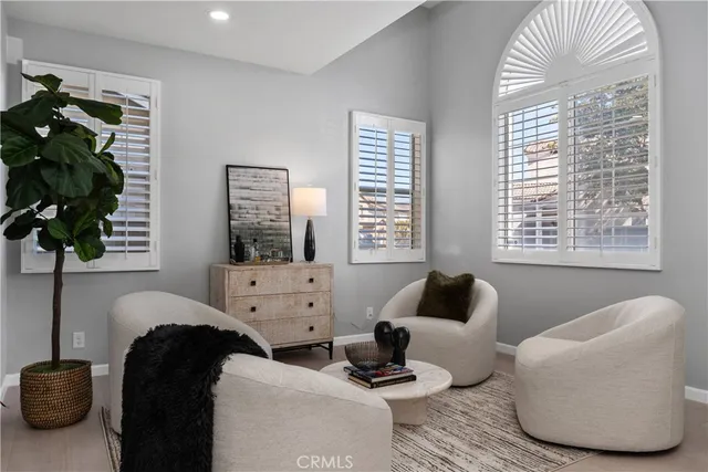 a living room with furniture and a potted plant
