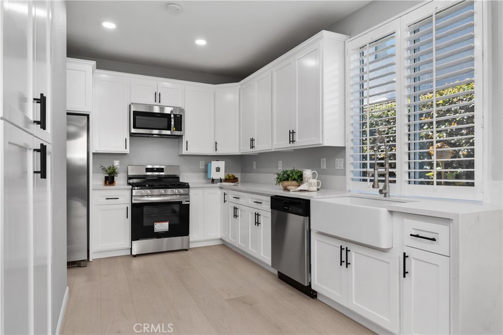 17 Nopalitos Way Aliso Viejo, CA 92656 - Photo 5 of 37 BRAND NEW KITCHEN! QUARTZ COUNTERTOP WITH WATERFULL EDGE, NEW CUSTOM SOFT CLOSE CABINETS, BRAND NEW SINK AND FAUCENT FIXTURE AND BRAND NEW APPLIANCES.