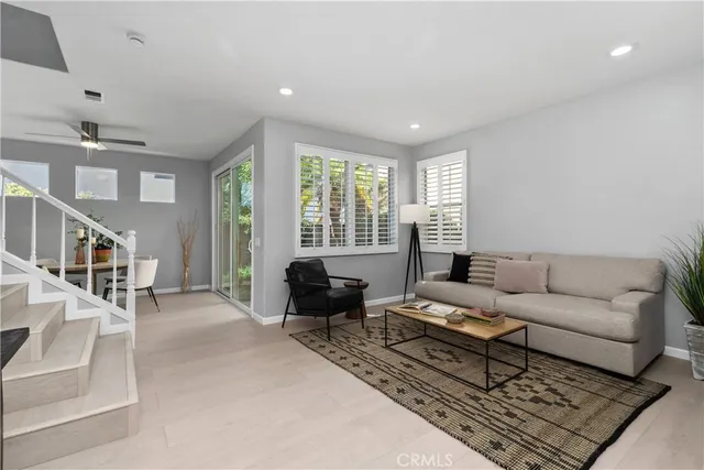 a view of a dining room with furniture and a potted plant