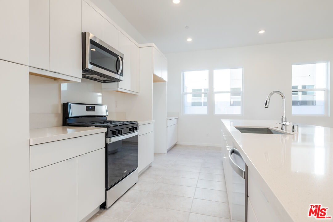 434 Hudson Street Brea, CA 92821 - Photo 16 of 44 a kitchen with a sink a stove and cabinets