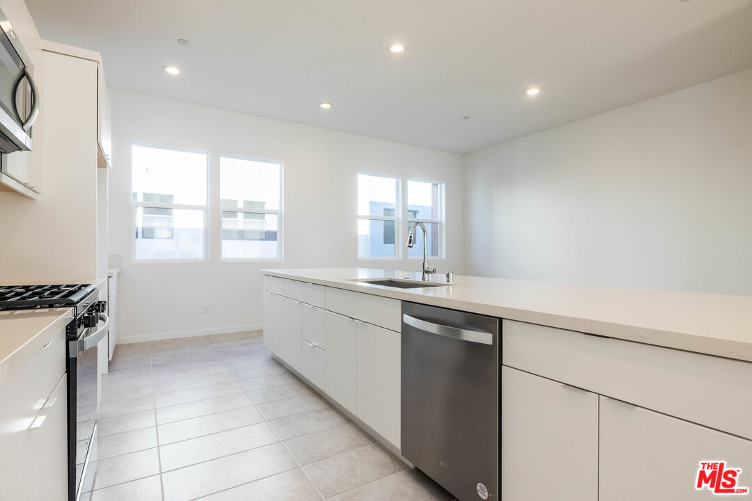 434 Hudson Street Brea, CA 92821 - Photo 17 of 44 a kitchen with a sink and a refrigerator