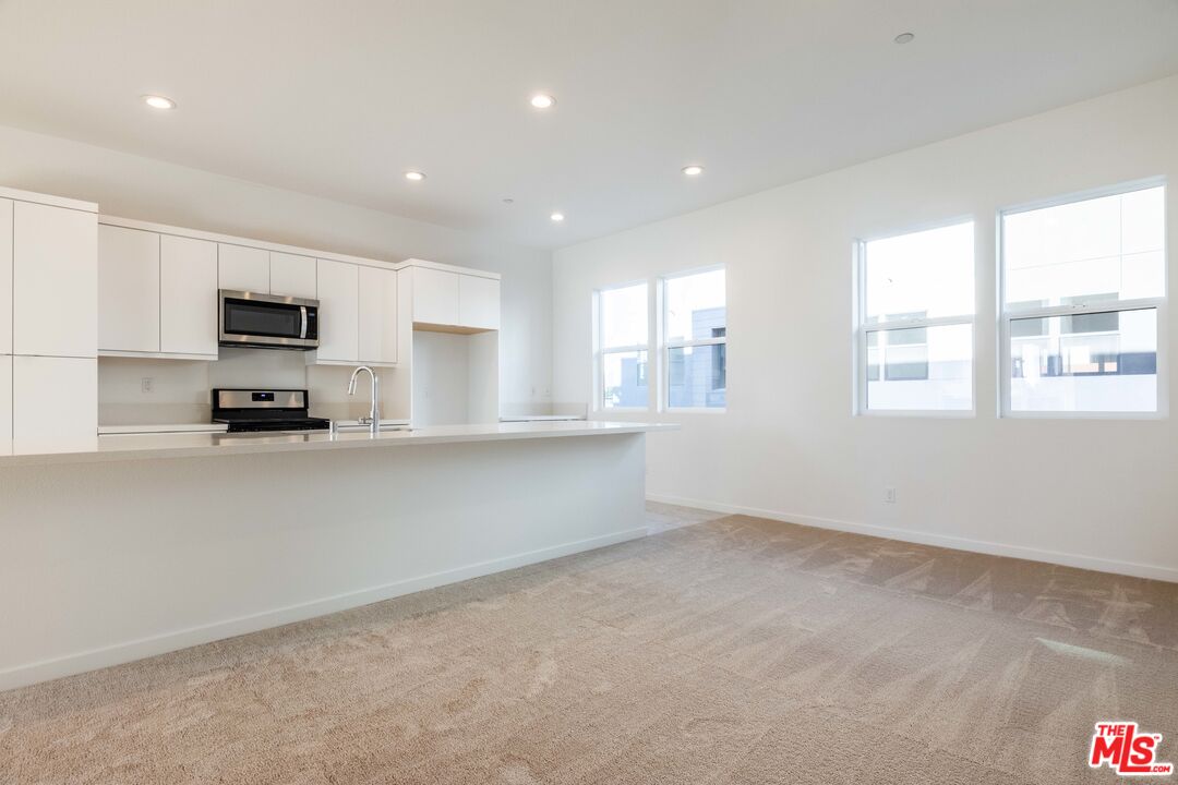 434 Hudson Street Brea, CA 92821 - Photo 21 of 44 a kitchen with granite countertop a stove a sink and a refrigerator
