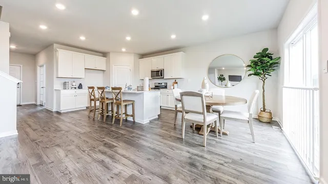 a view of a dining room with furniture and a potted plant