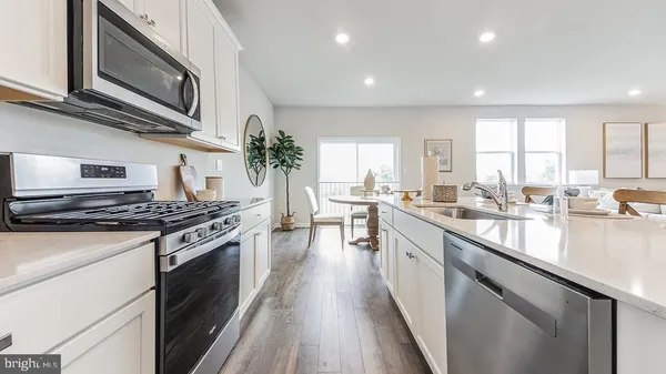 a kitchen with stainless steel appliances granite countertop a stove and a sink