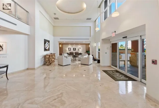 a living room with couches and painting on the wall