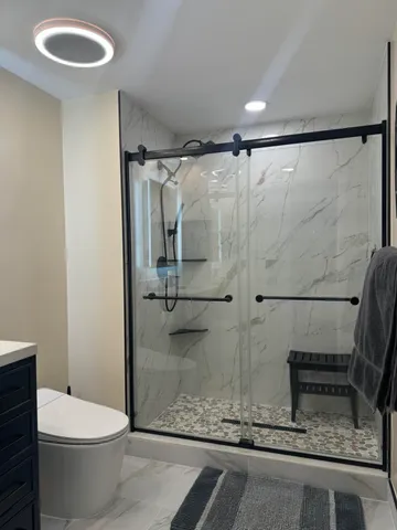 a bathroom with a toilet and a shower