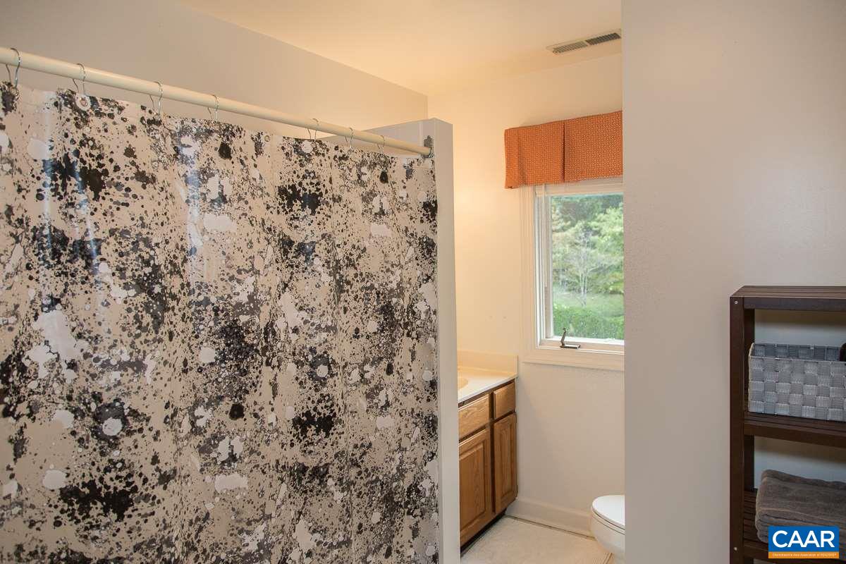 525 Rodes Drive Charlottesville, VA 22903 - Photo 29 of 40 a bathroom with a shower curtain