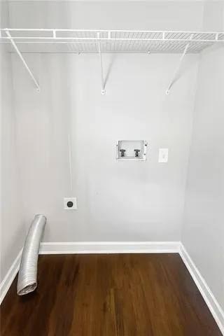 a view of a room with wooden floor and chair
