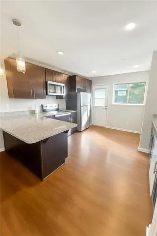 a kitchen with a sink refrigerator and cabinets