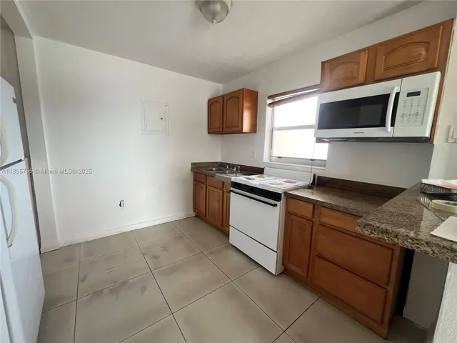a view of a bedroom with a bed and a window