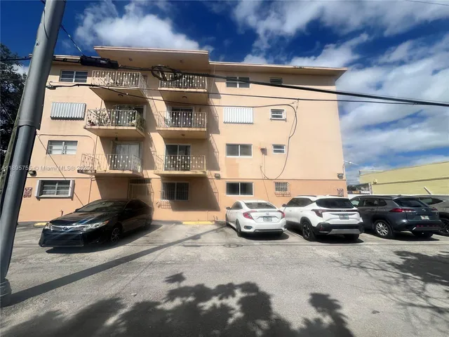 a city street with cars and a building