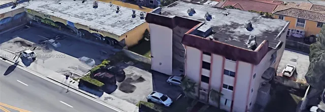 an aerial view of a residential apartment building with a table and chairs
