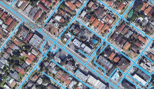 a view of a livingroom with furniture and floor to ceiling window