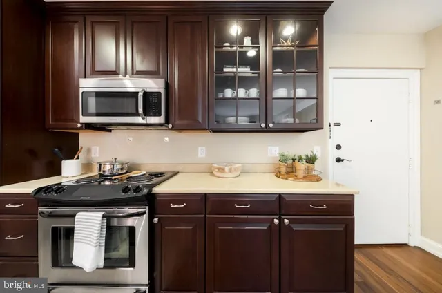 a kitchen with stainless steel appliances granite countertop a sink and a microwave