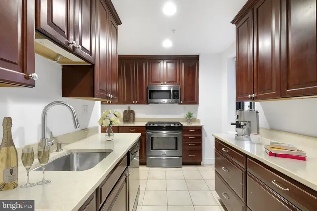 a kitchen with stainless steel appliances granite countertop a sink and stove
