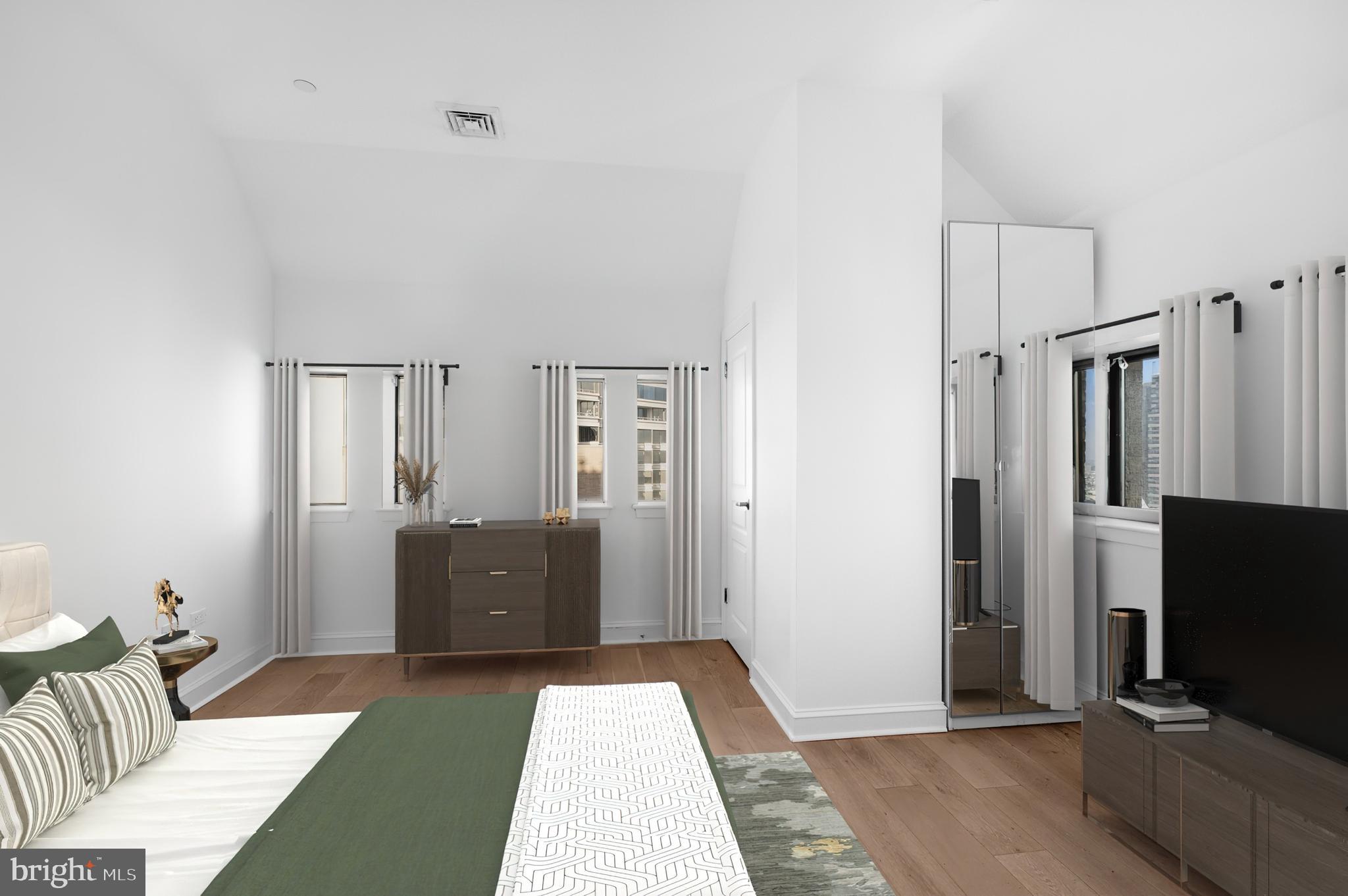 222 West Rittenhouse Square, Unit 1102 Philadelphia, PA 19103 - Photo 4 of 34 a bedroom with furniture and a flat screen tv