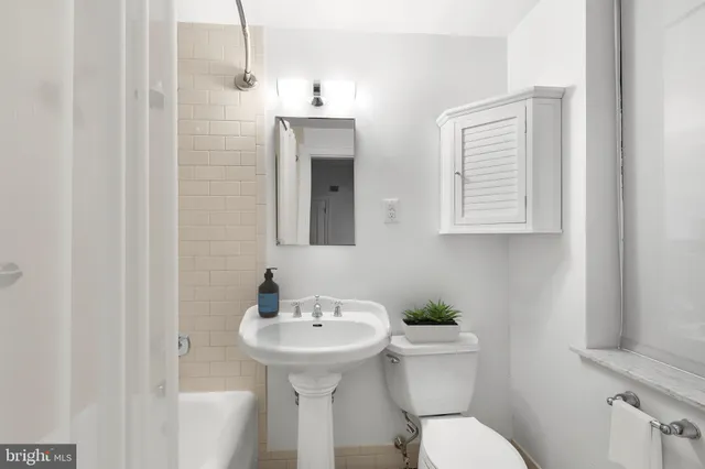 a bathroom with a sink toilet and mirror