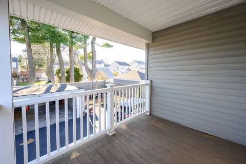 a view of a balcony with wooden floor
