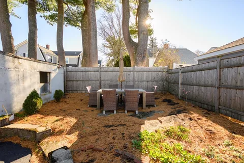 a view of a backyard with sitting area