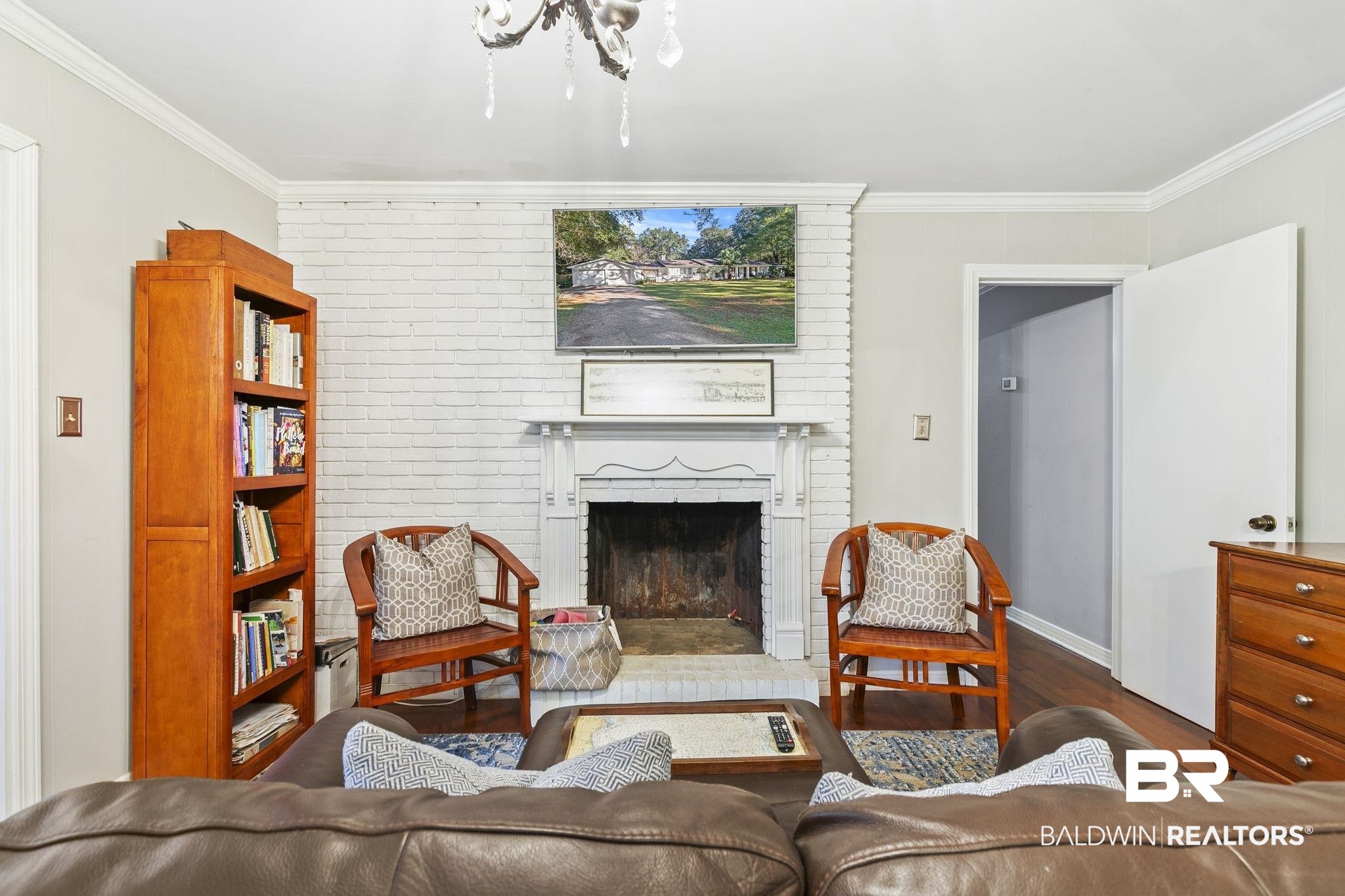 599 Hancock Road Fairhope, AL 36532 - Photo 5 of 23 Living room featuring a fireplace, hardwood / wood-style floors, and crown molding