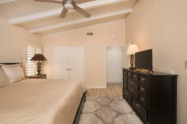 a bedroom with a bed and a tv