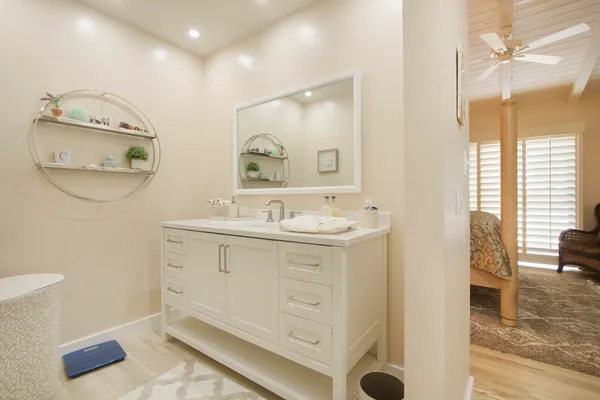 a bedroom with a large bed and a window