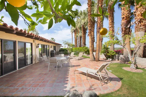a swimming pool with outdoor seating yard and patio