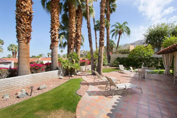 a view of backyard with swimming pool and sitting area