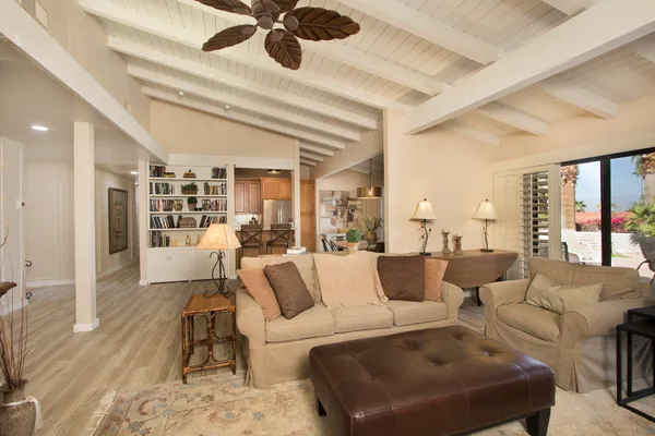 a dining room with furniture and wooden floor