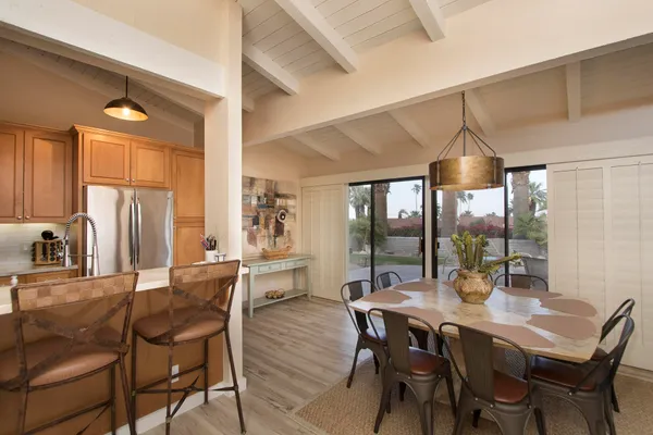 a living room with furniture a flat screen tv and a floor to ceiling window