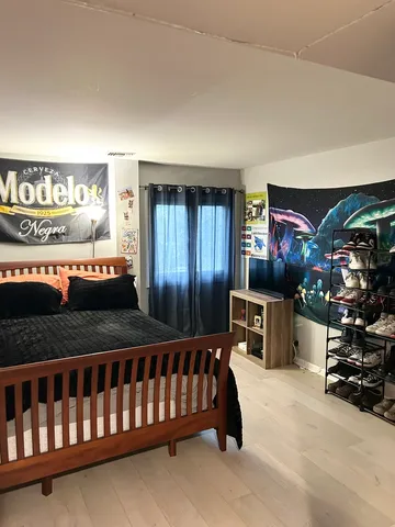 a bedroom with a bed and a tv