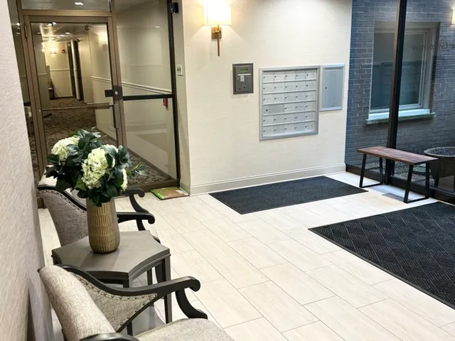 a bathroom with a granite countertop sink a toilet and a mirror