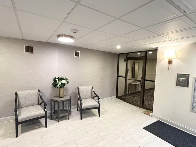 a living room with furniture and a mirror