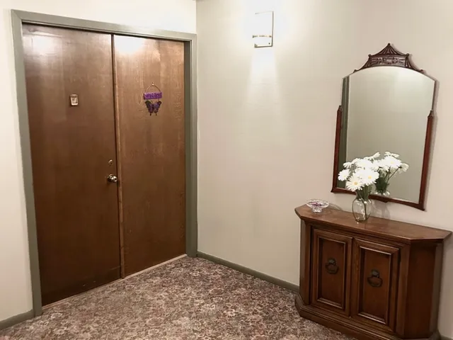 a room with kitchen island a sink wooden floor and a window